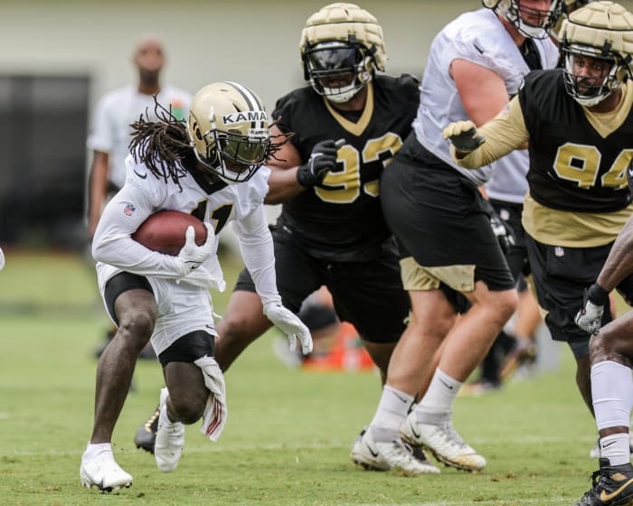 New Orleans Saints running back Alvin Kamara (41) against defensive tackle David Onyemata (93) and defensive end Cameron Jordan (94) during training camp. Mandatory Credit: Stephen Lew-USA TODAY